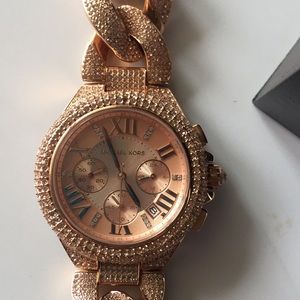Rose gold stone covered Michael Kors watch.